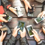 People group having addicted fun together using smartphones – Detail of hands sharing content on social network with mobile smart phones – Technology concept with millennials online with cellphones