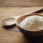 Oat flour in old wooden bowl