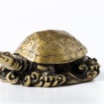 Feng shui golden metal turtle on white